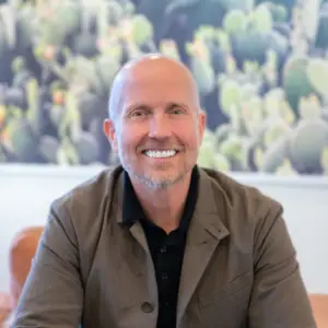 Derek Crain smiles into the camera.