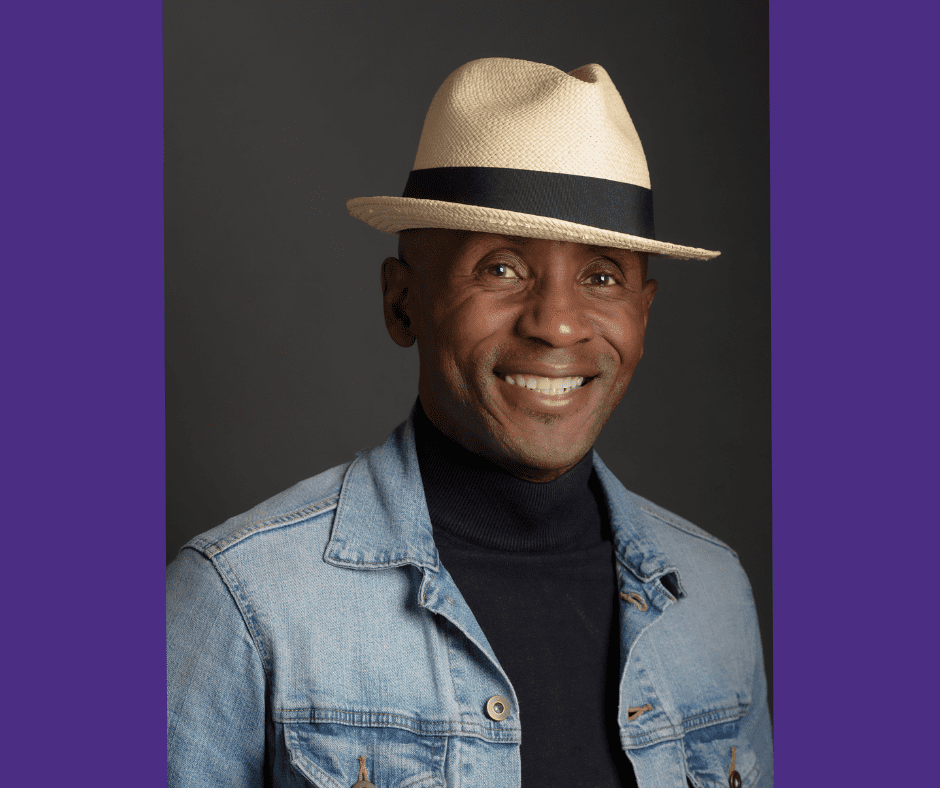 Dr. James sits for a professional headshot wearing a straw hat, black turtleneck and denim jacket.