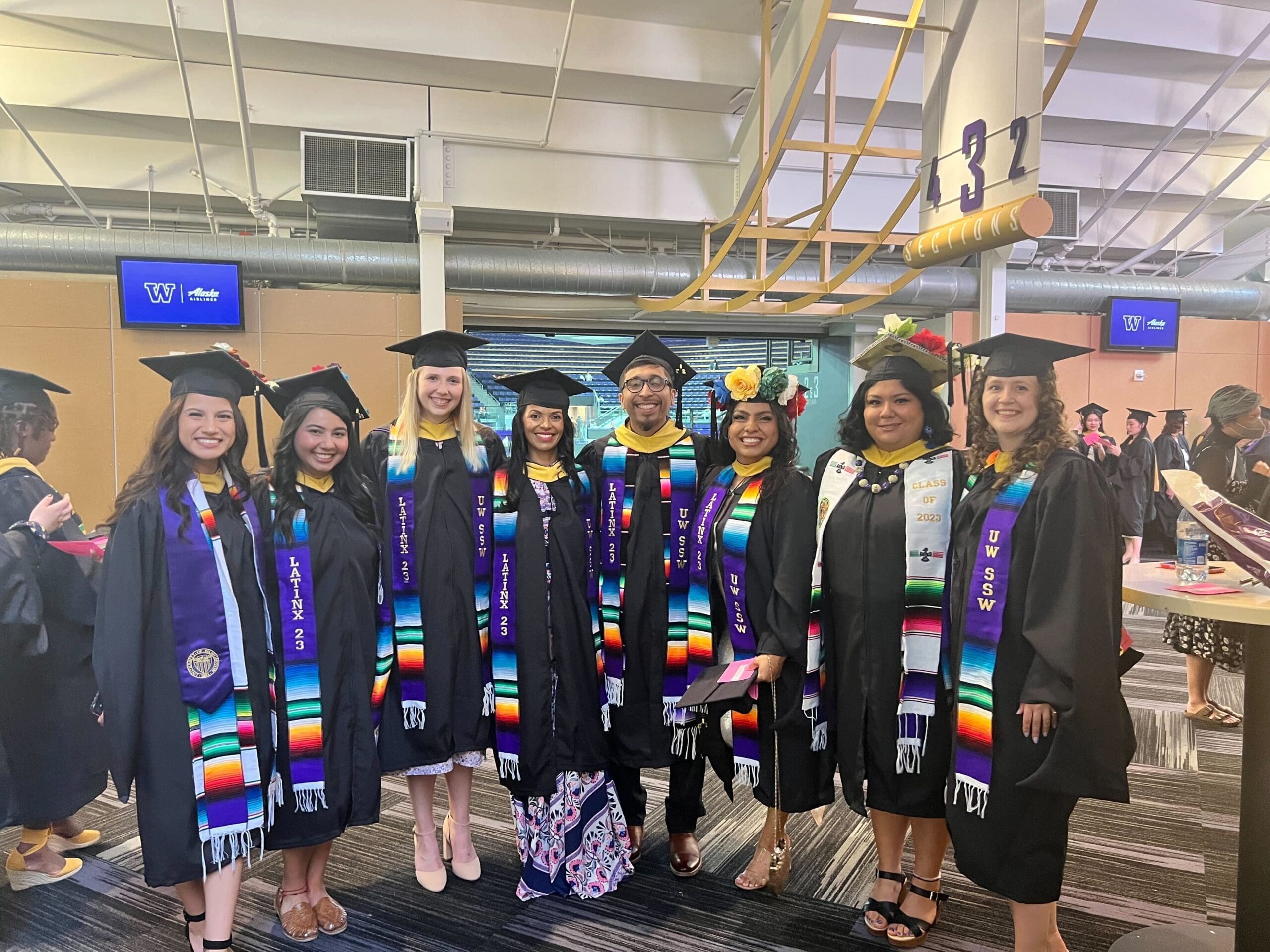 A group photo of the 2023 Latinx traineeship cohort, in graduation caps and gowns.